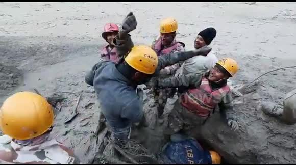 Indian rescuers pull worker alive from tunnel after devastating floods