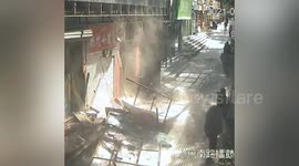 Shop billboards fall and crush woman sitting underneath in China