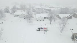 Fedex driver slides all over the road during large quick falling snow storm