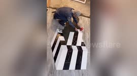 Chinese worker uses tiles to form disorientating 3D patterns on property floors
