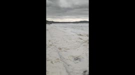 Fantastic footage as sea foam crashes onto shore in the wake of Storm Darcy