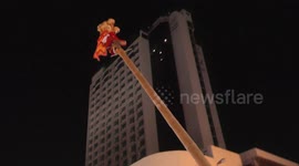 Dancer up a pole has a shaky descent during Chinese new year
