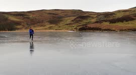 Man runs across frozen lake.