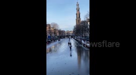 Dutch take to the ice as canals and lakes freeze over