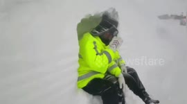Police officers dig hole in snow to shelter from blizzard in northwest China