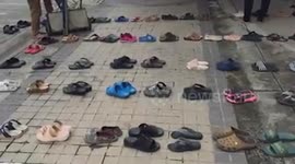 Patients use shoes to queue outside overcrowded hospital