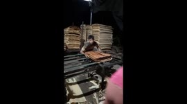 Vietnamese man collects rolled wood in fast speed