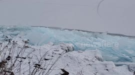 Blue lake ice stacks up shoreline of Lake Superior.