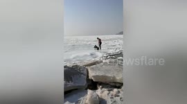 Winter swimmer saves elderly Chinese woman trapped in icy water