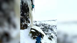A 12-year-old boy climbing a frozen waterfall that iced over during the recent cold weather