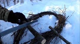 DIY improvised snowshoes using wood sticks in the middle of the wild
