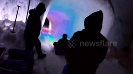 Walking through the ice caves and the slide carved in ice at the Ice Castles in New Hampshire