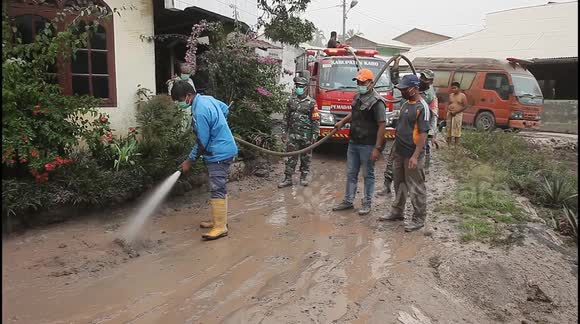 Residents clean up ash-covered streets after Indonesia volcanic eruption