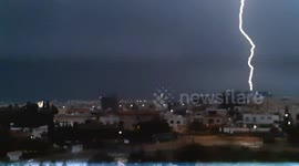 Double lightning strike with light build up before single point multiple strikes, Cyprus