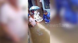 Bride and float through flood to get married in Indonesia