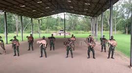 Soldiers carry dogs while doing squats as punishment