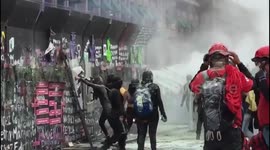 Female protesters tear down fences of the National Palace in Mexico