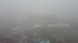 Heavy fog blankets northeast Thailand amid summer storms and rising humidity