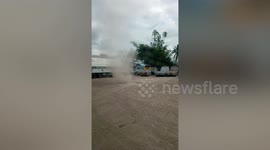 Dust devil tornado rips through car park in the Philippines