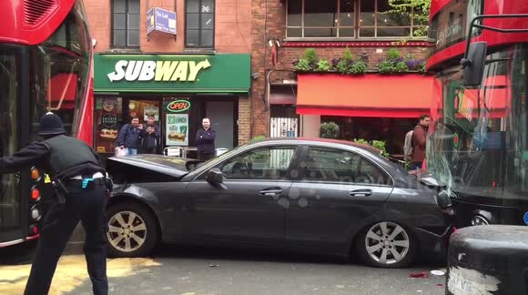 Mercedes crushed between two buses in London