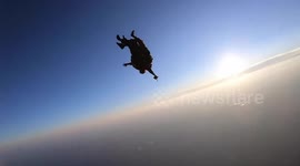 Stunning video shows environmentally friendly skydivers recite 100 strategies to stop global pollution as they plummet towards earth.