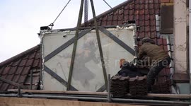 A Banksy which appeared on the side of a house just before it was sold appears to be being moved - after a massive crane arrived