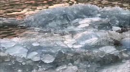 Crystalline shards of ice pile up along the shore of Long Pond lake in New York