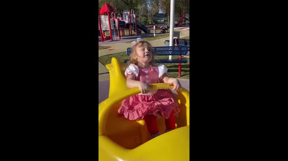 Whiplash airplane ride at the playground. Toddler vigorously riding toy.