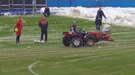 Bosnian way of clearing snow at the stadium before the match.