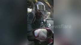 Chinese motorcyclist smashes car after being scared by its horn in dramatic road rage