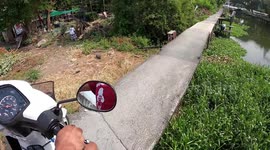 Nerve-wracking motorcycle ride along narrow canal path in Thailand