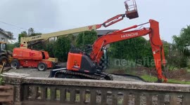 Flash flood river taking away tree on Oahu in hawaii heavy equipment to clear area nearby