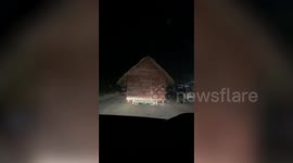 Truck carries entire HOUSE along the road to transport it to another village