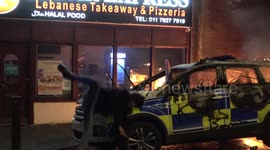 Protester SLIPS on burned-out bonnet of police car in Bristol during 'Kill the Bill' night of violence