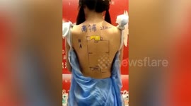 Property developer paints floor plans onto backs of female models causing controversy in north China