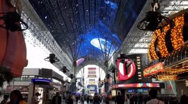 Zip liners zipping down Fremont Street in Las Vegas as it picks up during March Madnessss