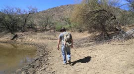 Juan Mario Cirett Galan walks alongside a small, almost dry dam. Wildlife project in Tonibabi ranch and ejido in Sierra La Madera, Moctezuma municipality, Sonora, Mexico.