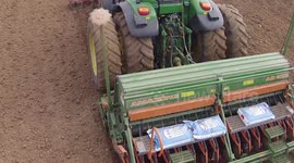Close up of sowing drill attached to a tractor as it plants Flax, or Linseed in the fields of Northern France