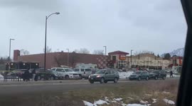 People gather outside Boulder King Soopers to pay respect to the 10 victims who died in yesterday’s mass shooting in Boulder Colorado