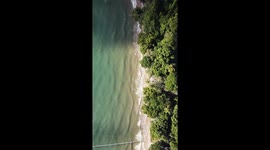Birdseye Drone Footage of Big Rain Cloud Rolling Over Etty Bay Beach Tropical North Queensland Australia