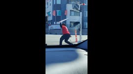 Las Vegas motorist amazed by skilful sign spinner's routine