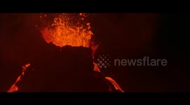 This video shows a drone's night-time flyover of a volcano eruption site in Iceland