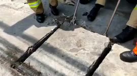 Fire Team Evacuation Headsets of Residents Fall in Gorong Goring Drains in East Jakarta, Indonesia