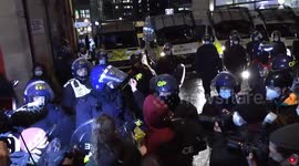 Protesters place flowers on uniform of police officers during Bristol protest