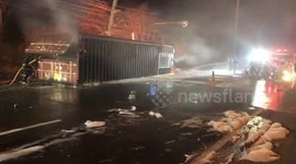 Container truck explodes in front of firemen tackling blaze