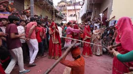 Hundreds of women hit men with sticks during Lathmar Holi celebrations
