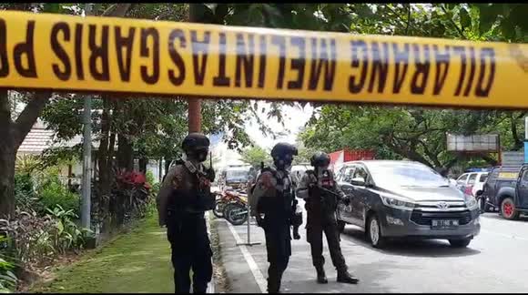 Armed police secure area outside Catholic church in Indonesia, scene of suicide attack
