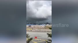 Waterspout towers over buildings before rainstorm in Indonesia