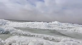 High winds see shards of ice pile up on shore of lake in Minnesota, US
