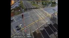 Terrifying moment man misses oncoming train by inches at level crossing